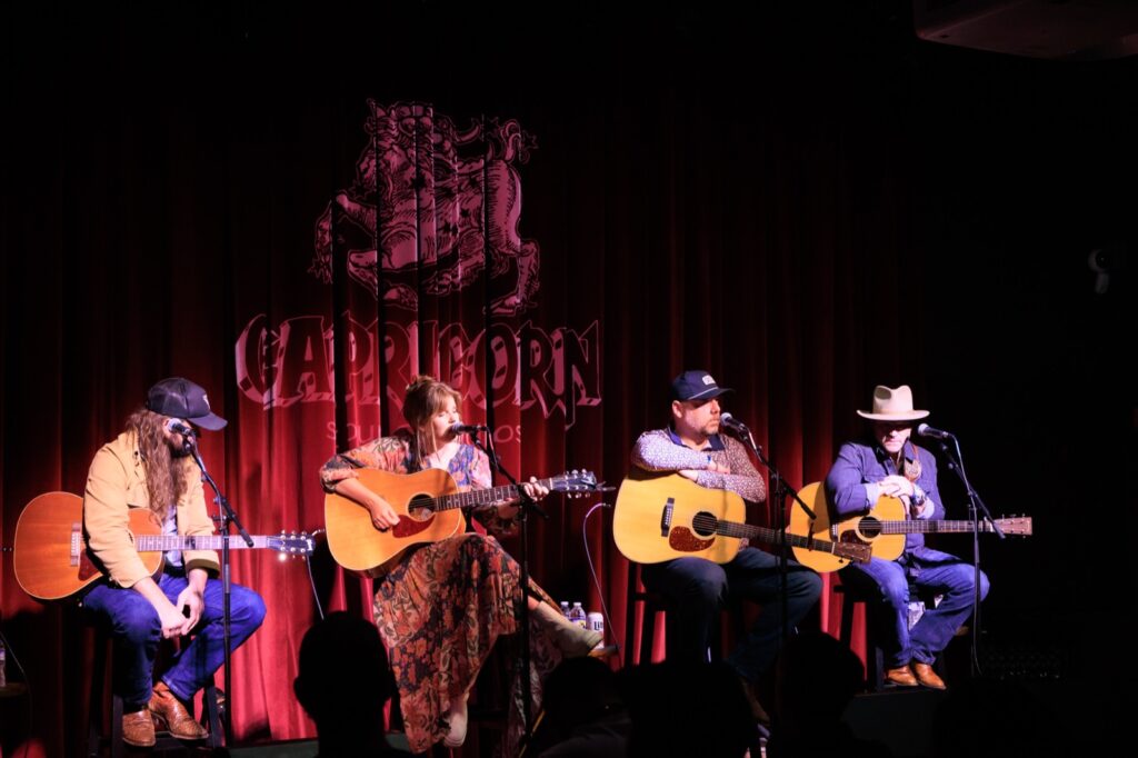 Four musicians on stage at Capricorn