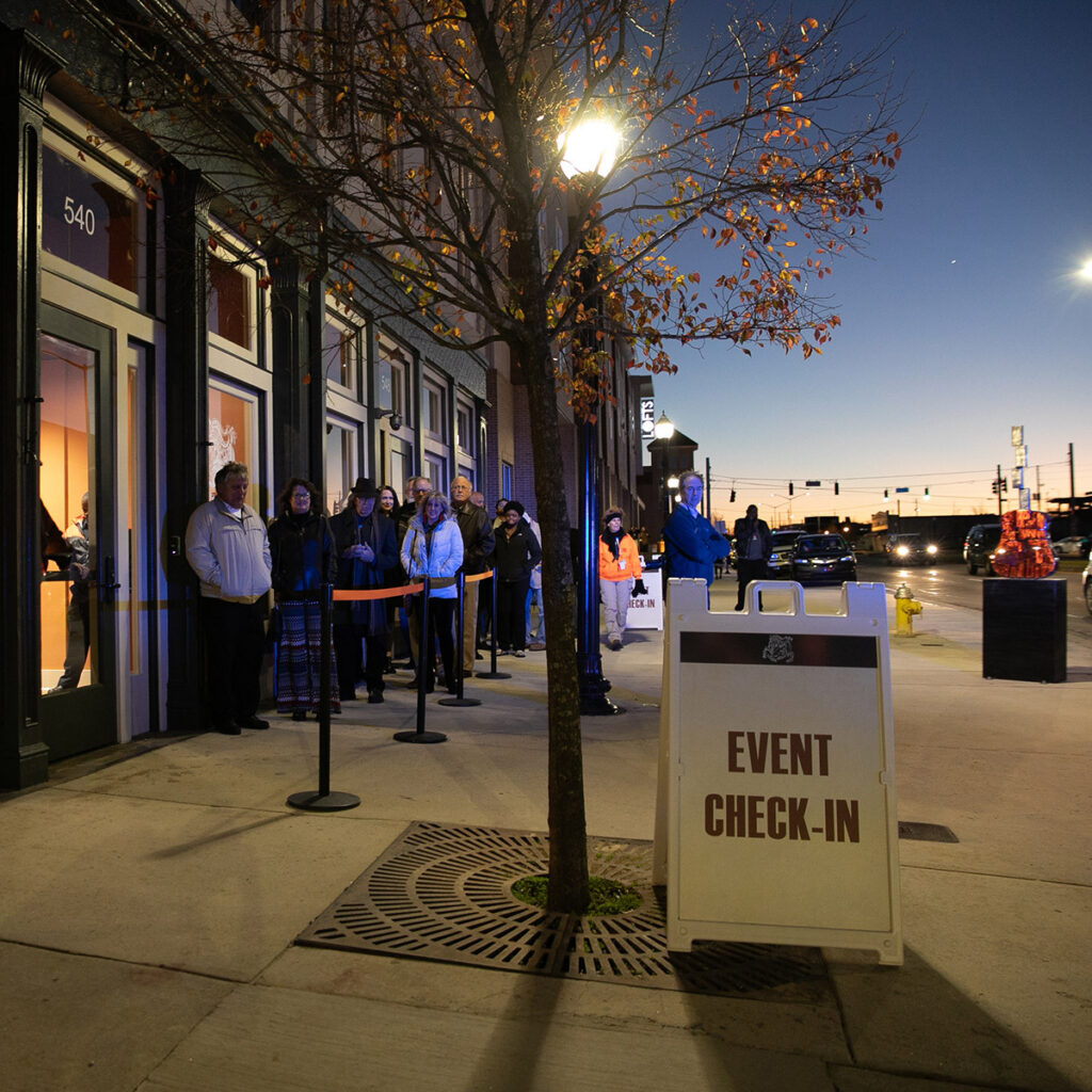 Visitors waiting in a line outside at Capricorn