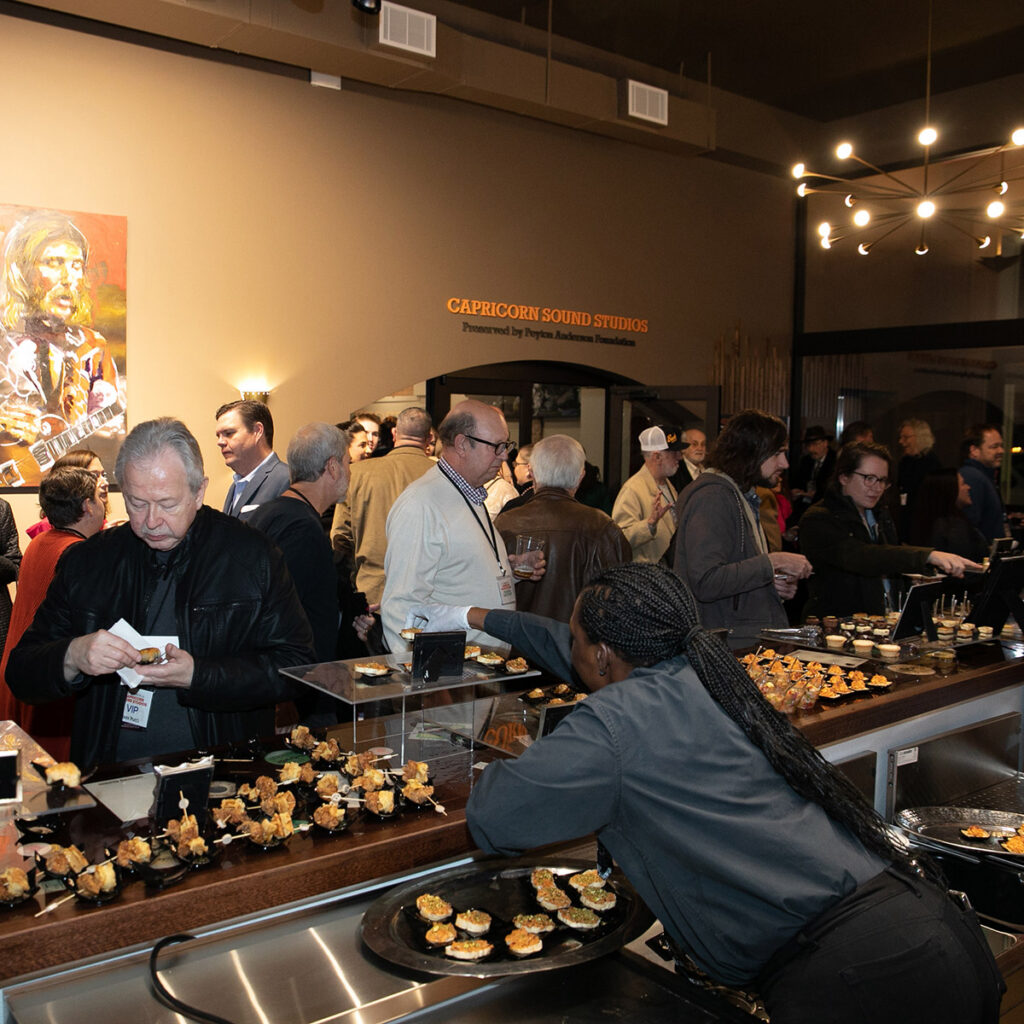 Visitors eating refreshments at an event at Capricorn